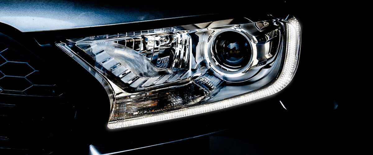 Headlights with chrome background, LED accents and a projector lens