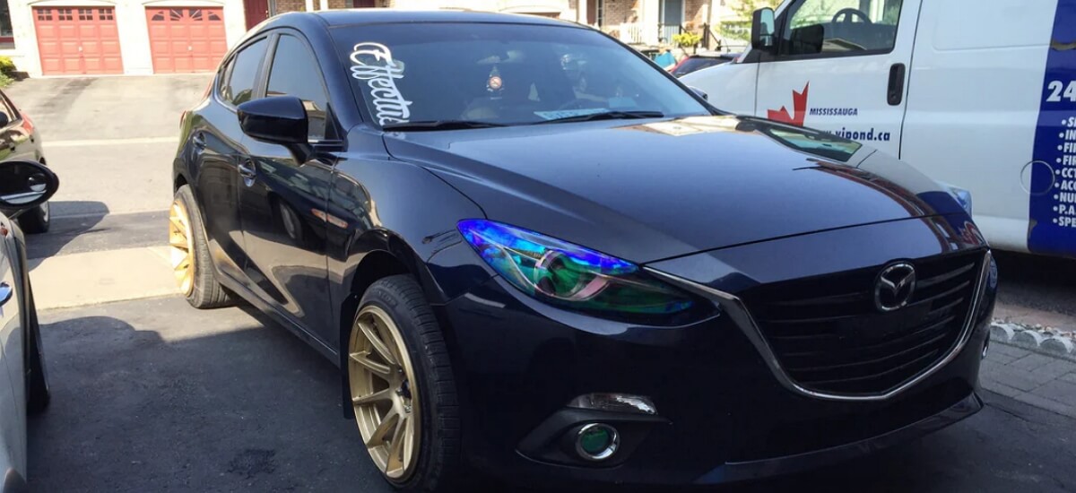Mazda with headlights wrapped with neo chrome chameleon tint