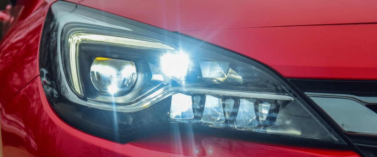 Red car with LED halo projector headlights